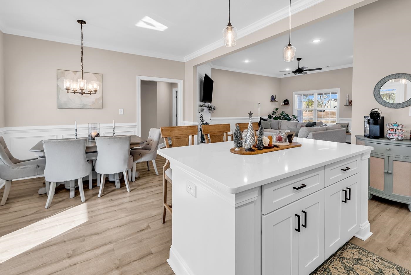 384 William Nobles Road Aynor, SC 29511 - Photo 38 of 38 Kitchen featuring white cabinets, open floor plan, ornamental molding, decorative light fixtures, and light wood finished floors