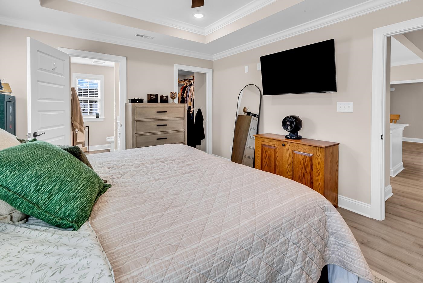 384 William Nobles Road Aynor, SC 29511 - Photo 21 of 38 Bedroom with crown molding, a raised ceiling, a ceiling fan, wood finished floors, and a walk in closet