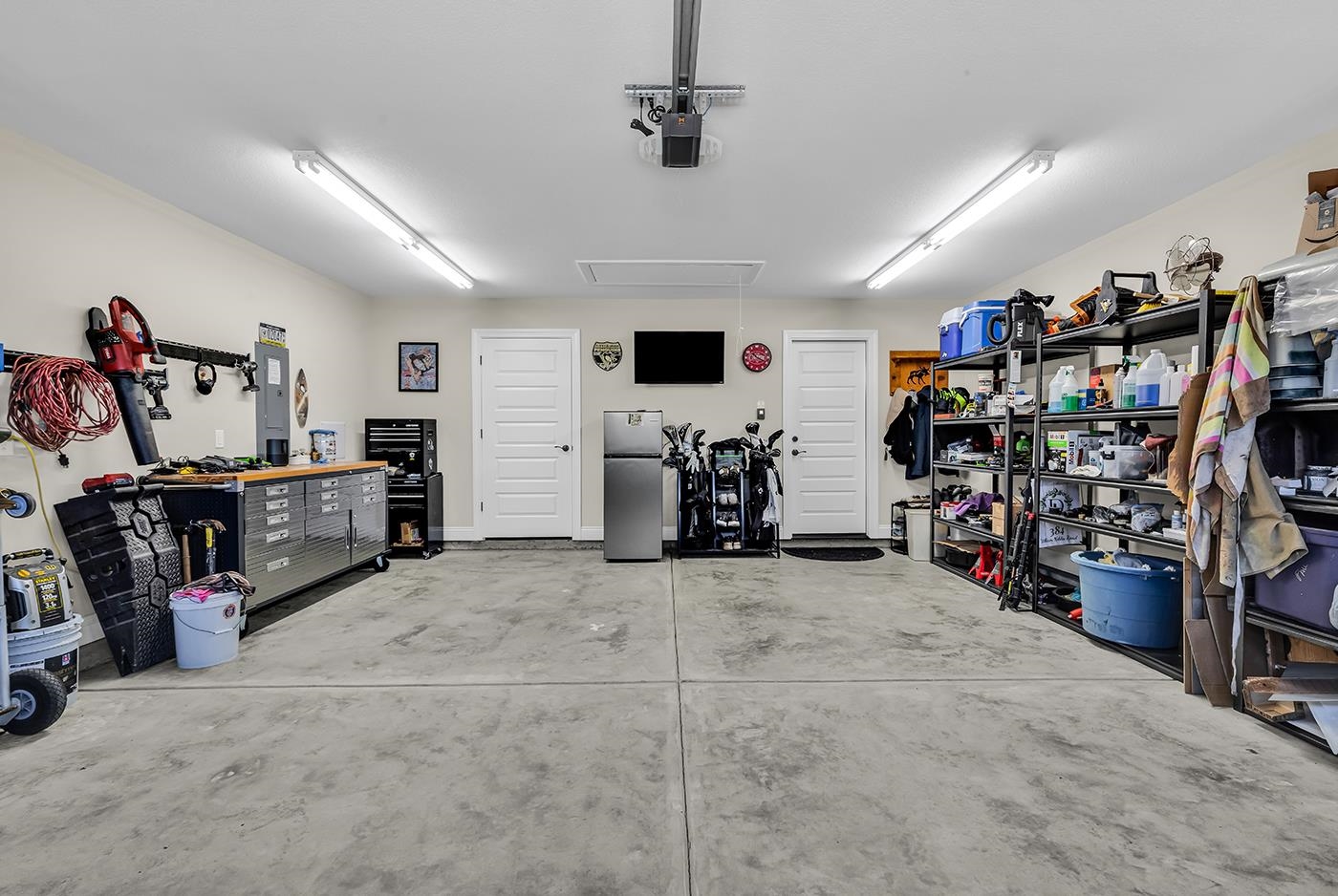 384 William Nobles Road Aynor, SC 29511 - Photo 33 of 38 Garage with freestanding refrigerator, electric panel, a workshop area, and a garage door opener