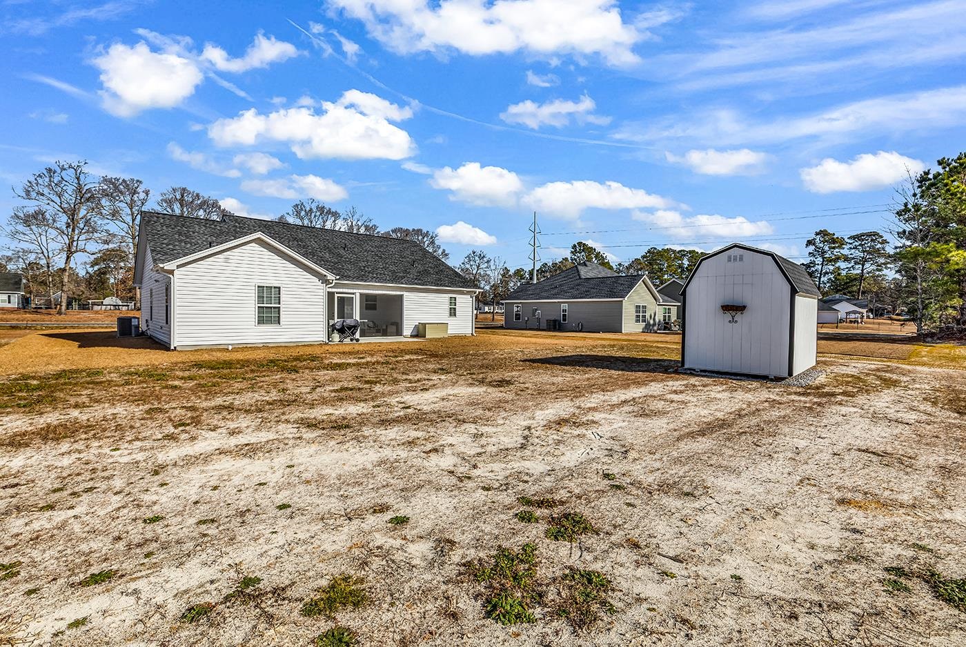384 William Nobles Road Aynor, SC 29511 - Photo 36 of 38 Rear view of house with a storage shed, a patio area, and a residential view