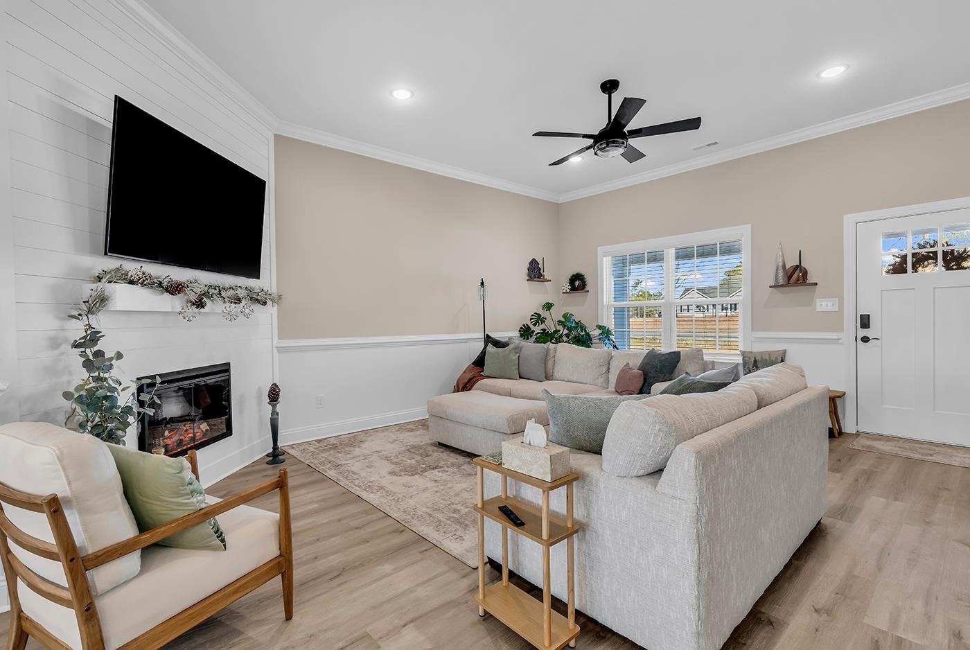 384 William Nobles Road Aynor, SC 29511 - Photo 6 of 38 Living room with light wood finished floors, ornamental molding, a glass covered fireplace, recessed lighting, and ceiling fan