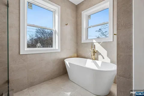a white tub sitting next to a bathroom