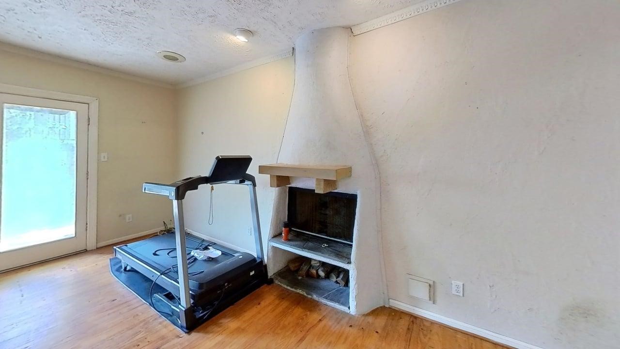 1905 Bissonnet Street Houston, TX 77005 - Photo 9 of 27 Den area secondary fireplace. French doors lead to the backyard.