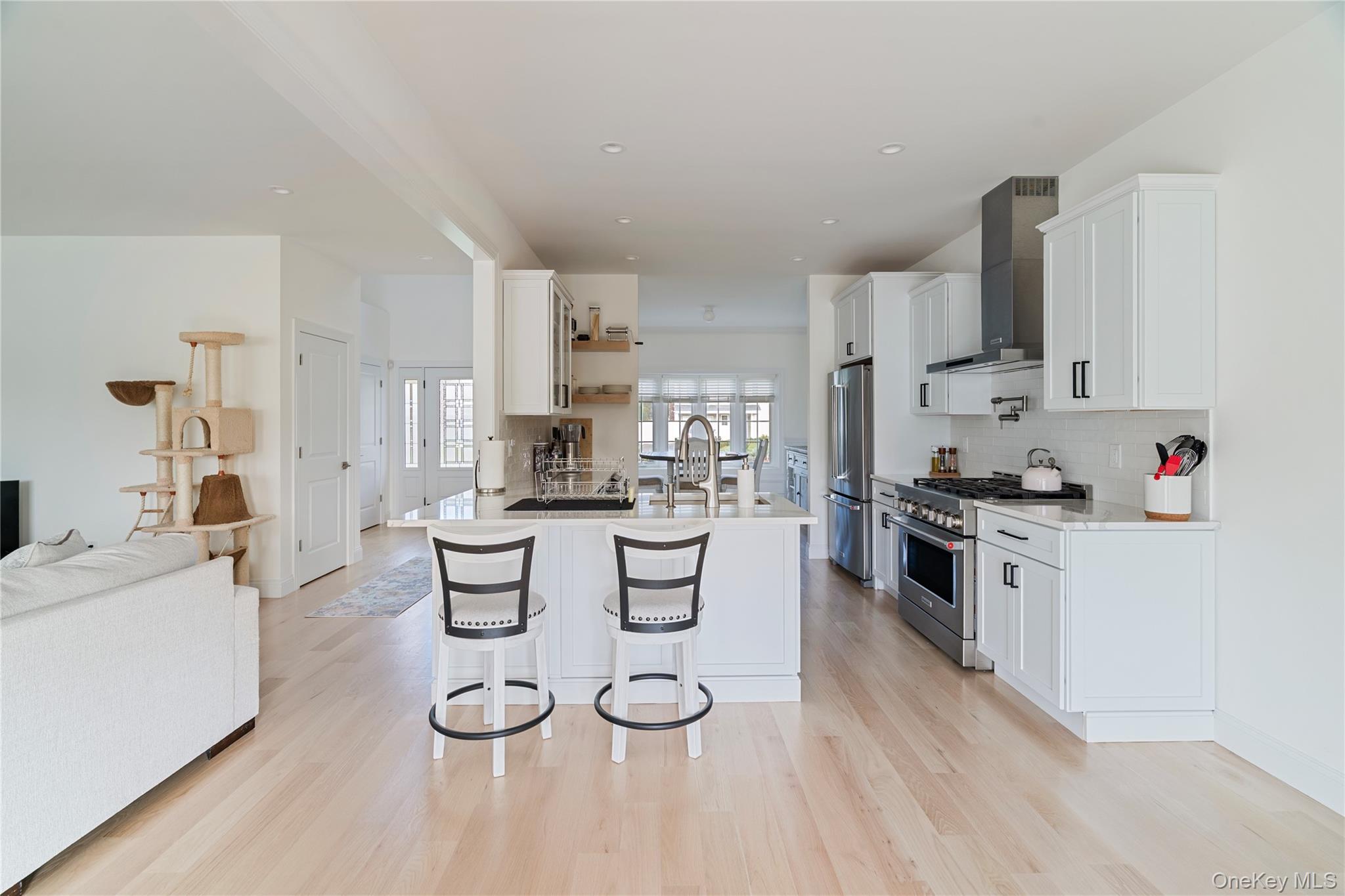 60 Parsnip Pond Road Lake Grove, NY 11755 - Photo 30 of 32 a kitchen with white cabinets and white appliances