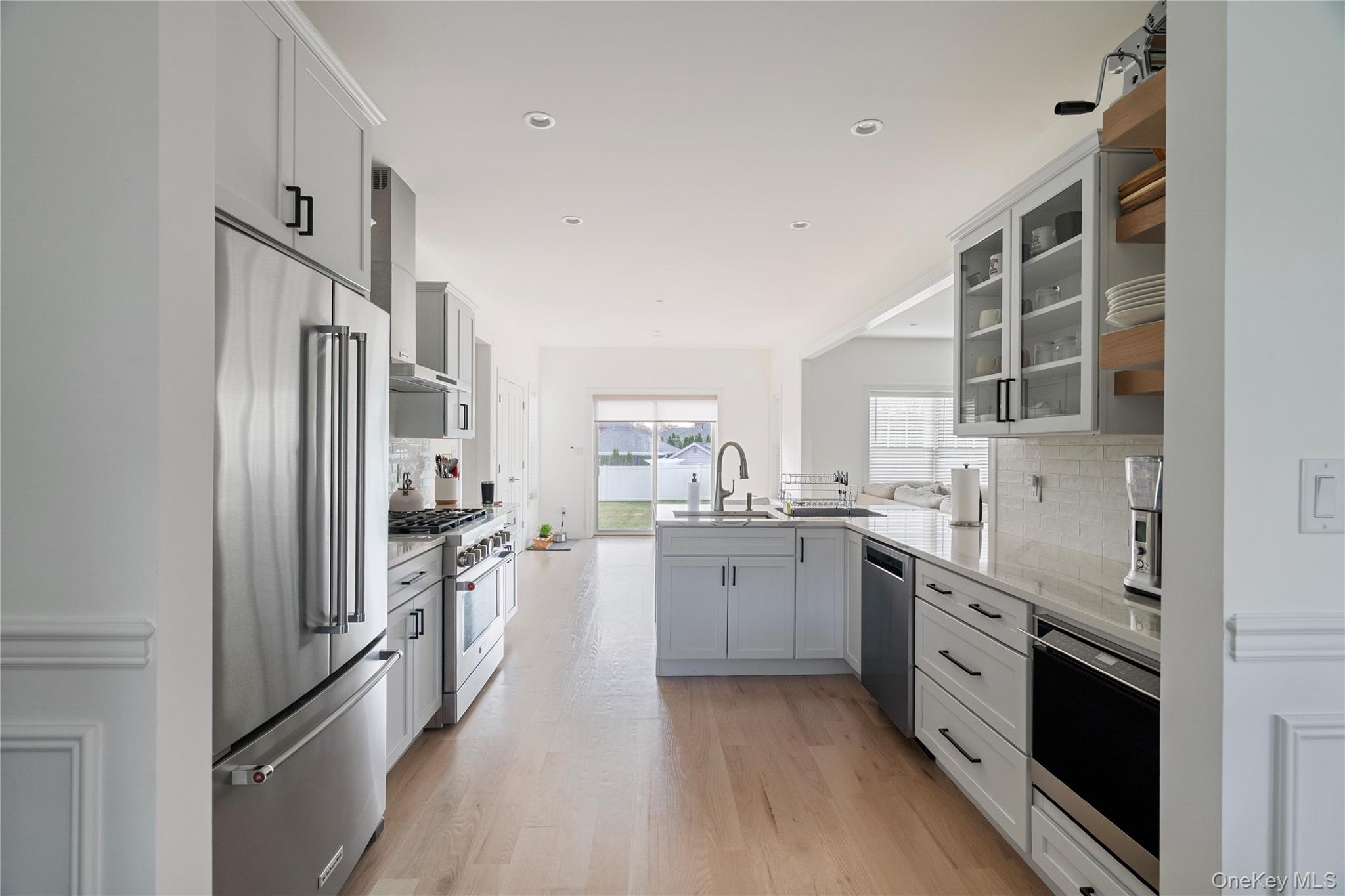60 Parsnip Pond Road Lake Grove, NY 11755 - Photo 12 of 32 a kitchen with stainless steel appliances a sink stove refrigerator and cabinets