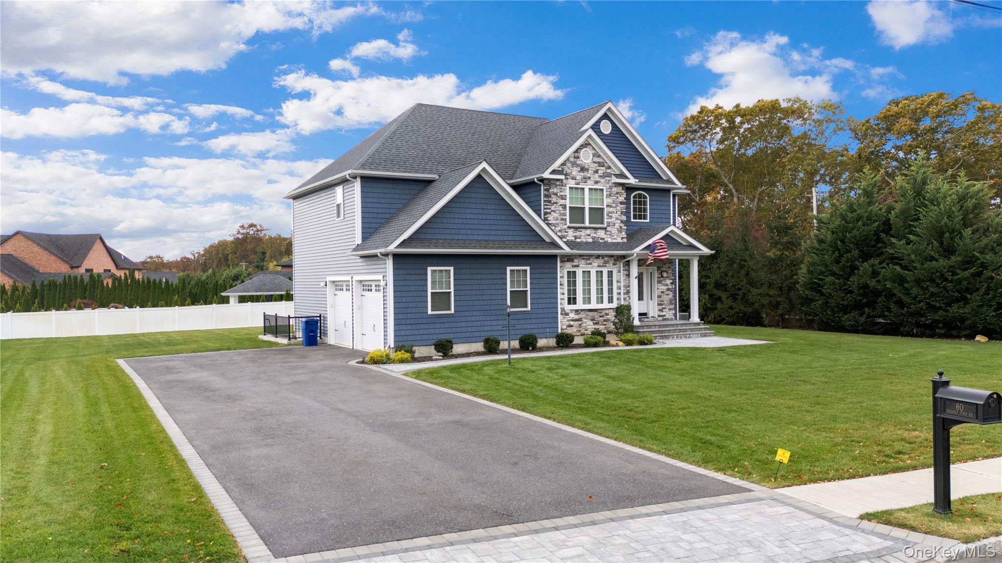 60 Parsnip Pond Road Lake Grove, NY 11755 - Photo 2 of 32 a front view of a house with a yard