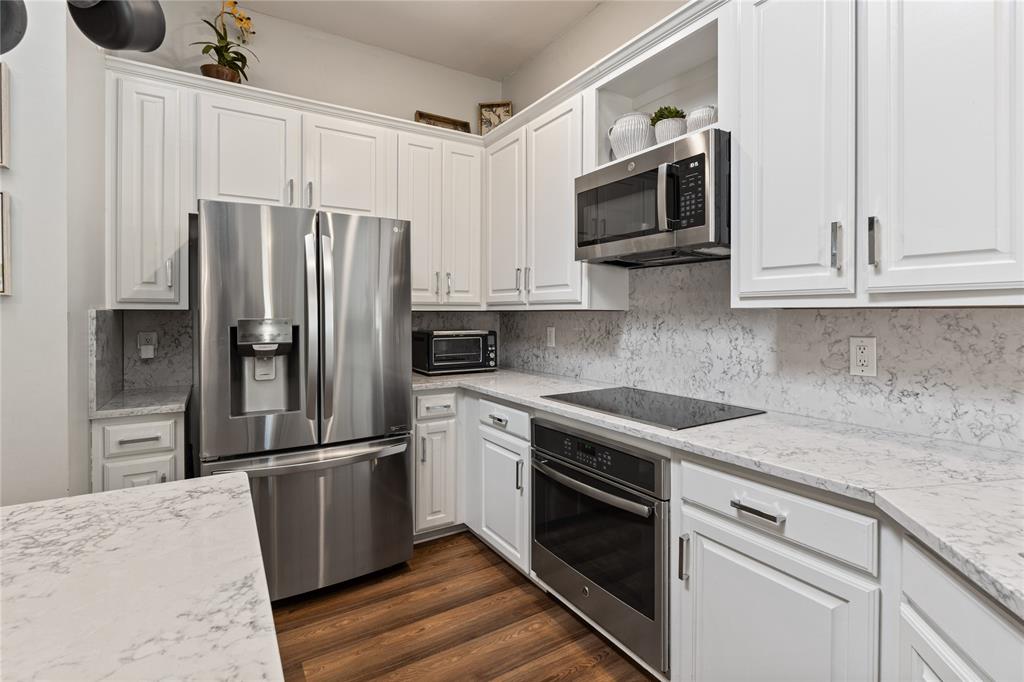 8718 Falls Road Irving, TX 75063 - Photo 12 of 28 a kitchen with stainless steel appliances granite countertop a refrigerator stove and microwave