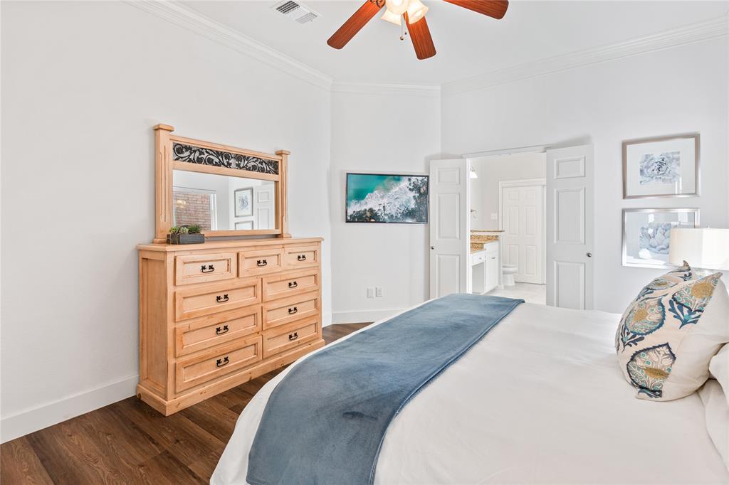 8718 Falls Road Irving, TX 75063 - Photo 15 of 28 a bedroom with a bed and a dresser