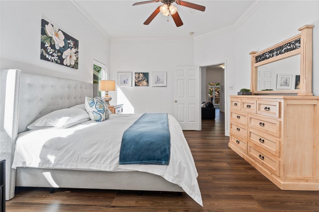 8718 Falls Road Irving, TX 75063 - Photo 16 of 28 a bedroom with a large bed and a chandelier