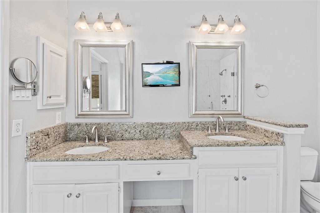 8718 Falls Road Irving, TX 75063 - Photo 18 of 28 a bathroom with a sink double vanity and a mirror