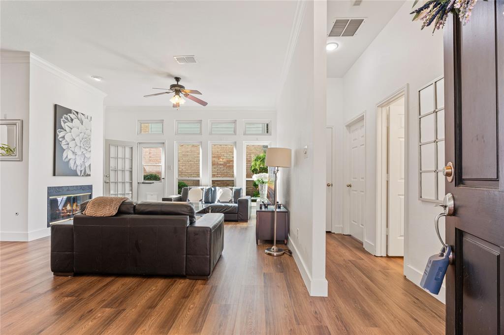 8718 Falls Road Irving, TX 75063 - Photo 4 of 28 a living room with furniture a large window and wooden floor