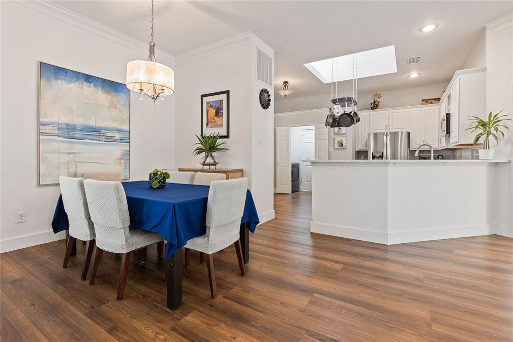 8718 Falls Road Irving, TX 75063 - Photo 8 of 28 a view of a dining room with furniture and wooden floor