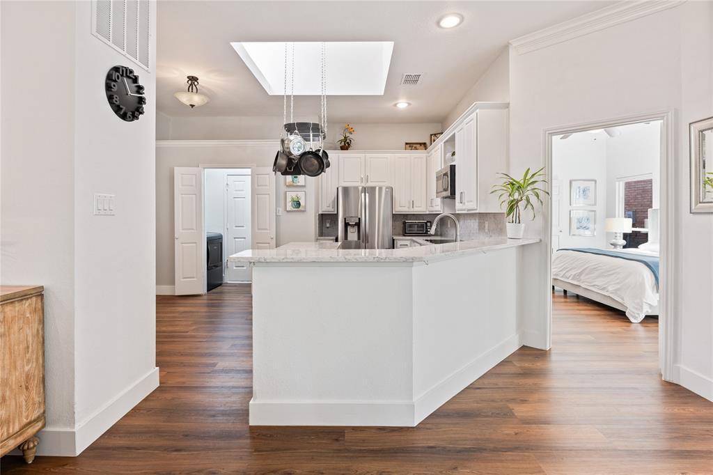 8718 Falls Road Irving, TX 75063 - Photo 9 of 28 a living room with kitchen island furniture and a chandelier