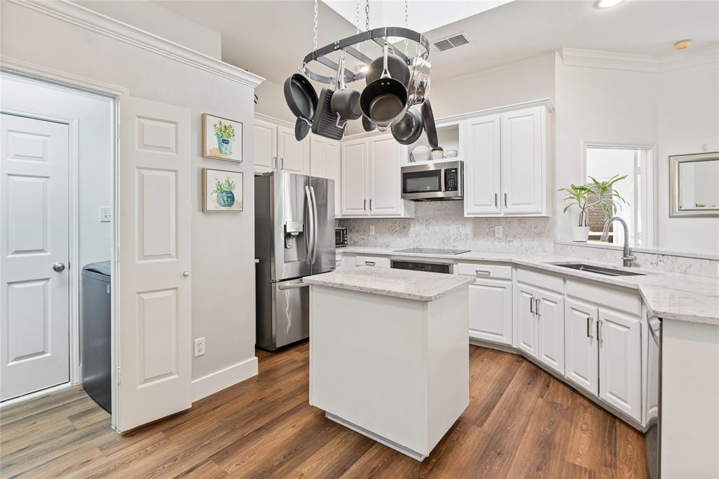 8718 Falls Road Irving, TX 75063 - Photo 10 of 28 a kitchen with a white cabinets and white appliances