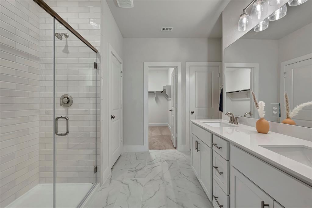 2624 Lewisville Road Celina, TX 75009 - Photo 11 of 40 a spacious bathroom with a shower sink and mirror
