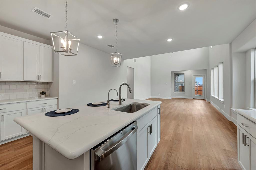2624 Lewisville Road Celina, TX 75009 - Photo 16 of 40 a kitchen with sink a stove and cabinets