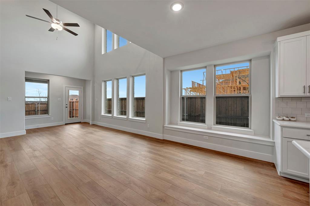 2624 Lewisville Road Celina, TX 75009 - Photo 18 of 40 a view of an empty room with a window and wooden floor