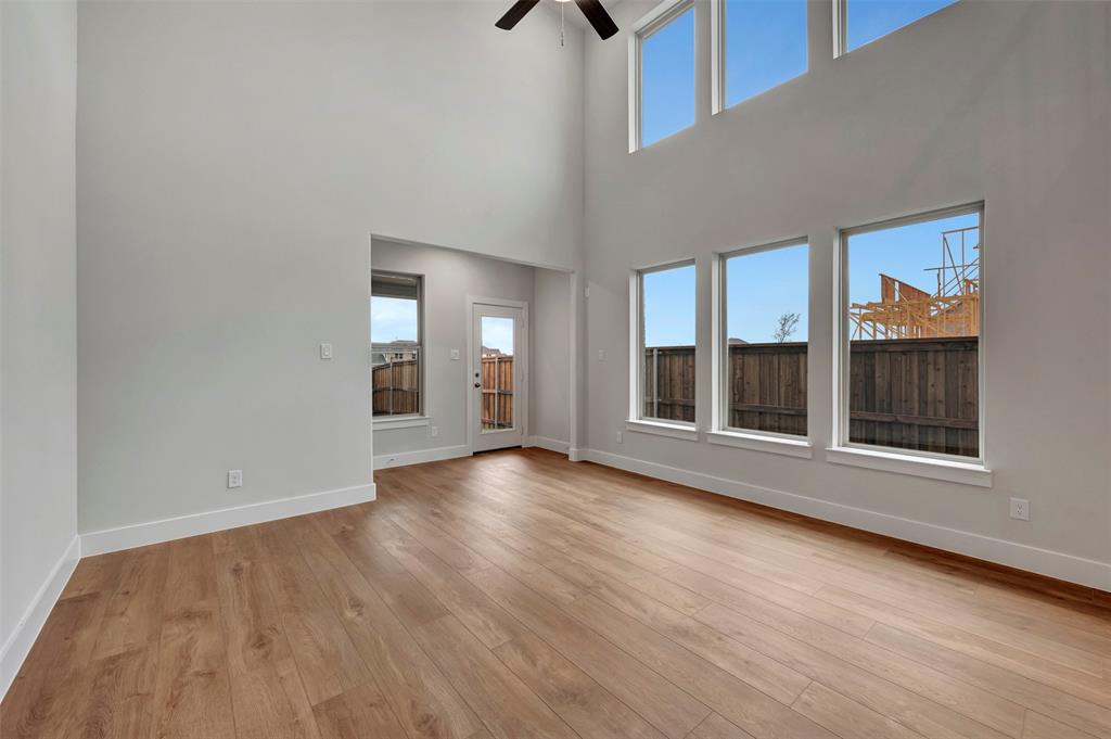 2624 Lewisville Road Celina, TX 75009 - Photo 2 of 40 an empty room with wooden floor and windows