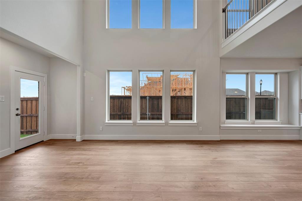 2624 Lewisville Road Celina, TX 75009 - Photo 24 of 40 an empty room with wooden floor and windows