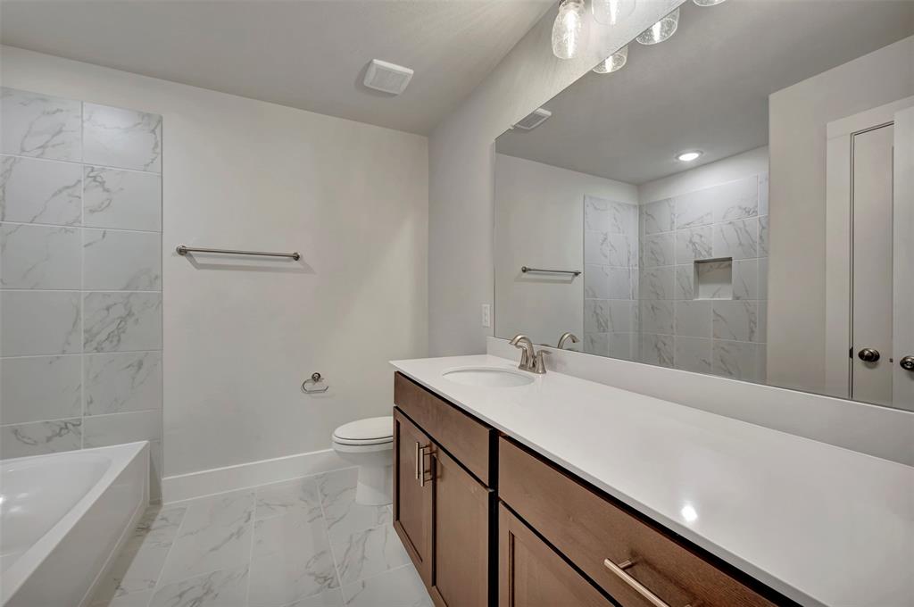 2624 Lewisville Road Celina, TX 75009 - Photo 34 of 40 a bathroom with a sink a toilet and shower