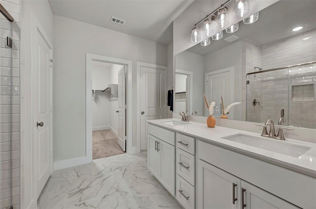 2624 Lewisville Road Celina, TX 75009 - Photo 5 of 40 a spacious bathroom with double vanity a and a shower