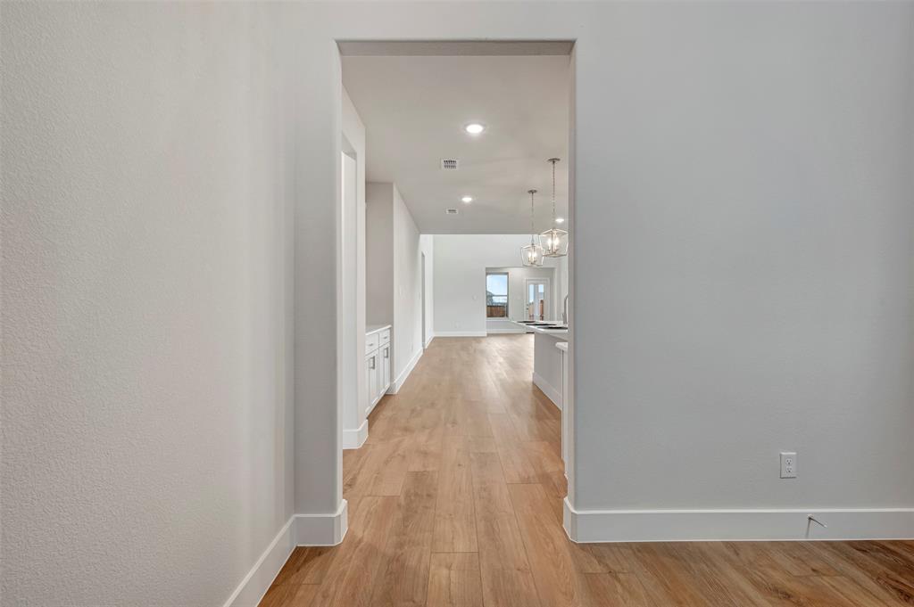 2624 Lewisville Road Celina, TX 75009 - Photo 6 of 40 a view of a room with wooden floor