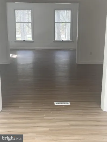 an empty room with a empty space and windows