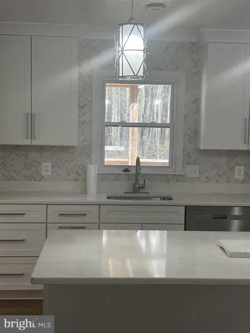 a bathroom with a sink and a window