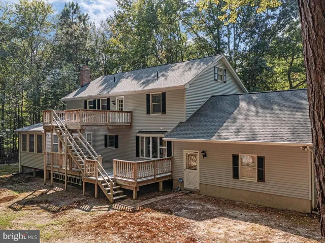 a view of balcony with deck and yard
