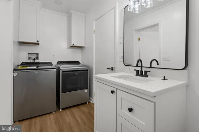 a utility room with sink dryer and washer