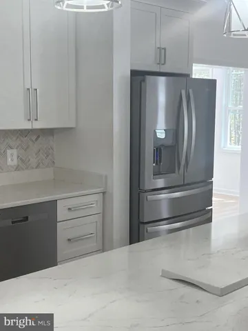 a kitchen with refrigerator and window