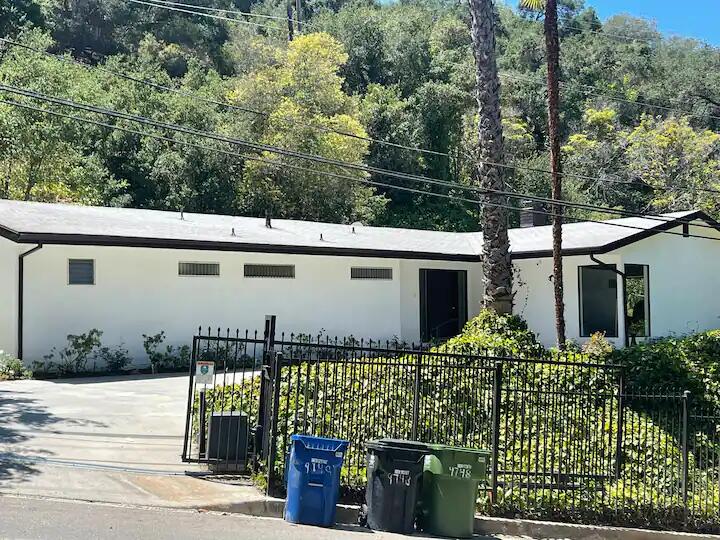 9748 Oak Pass Road Beverly Hills, CA 90210 - Photo 12 of 35 a front view of a house with garden