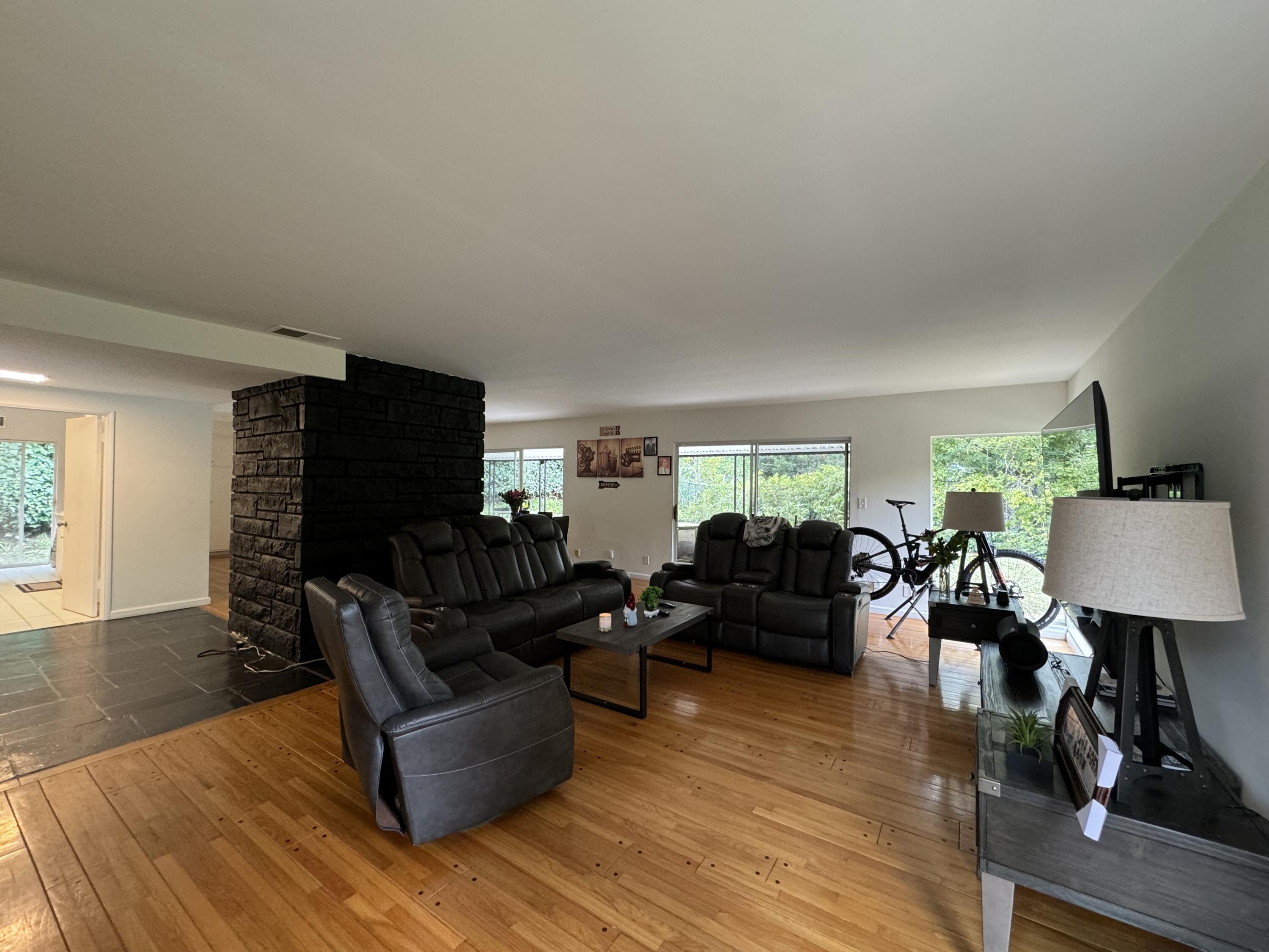 9748 Oak Pass Road Beverly Hills, CA 90210 - Photo 13 of 35 a living room with furniture and a flat screen tv