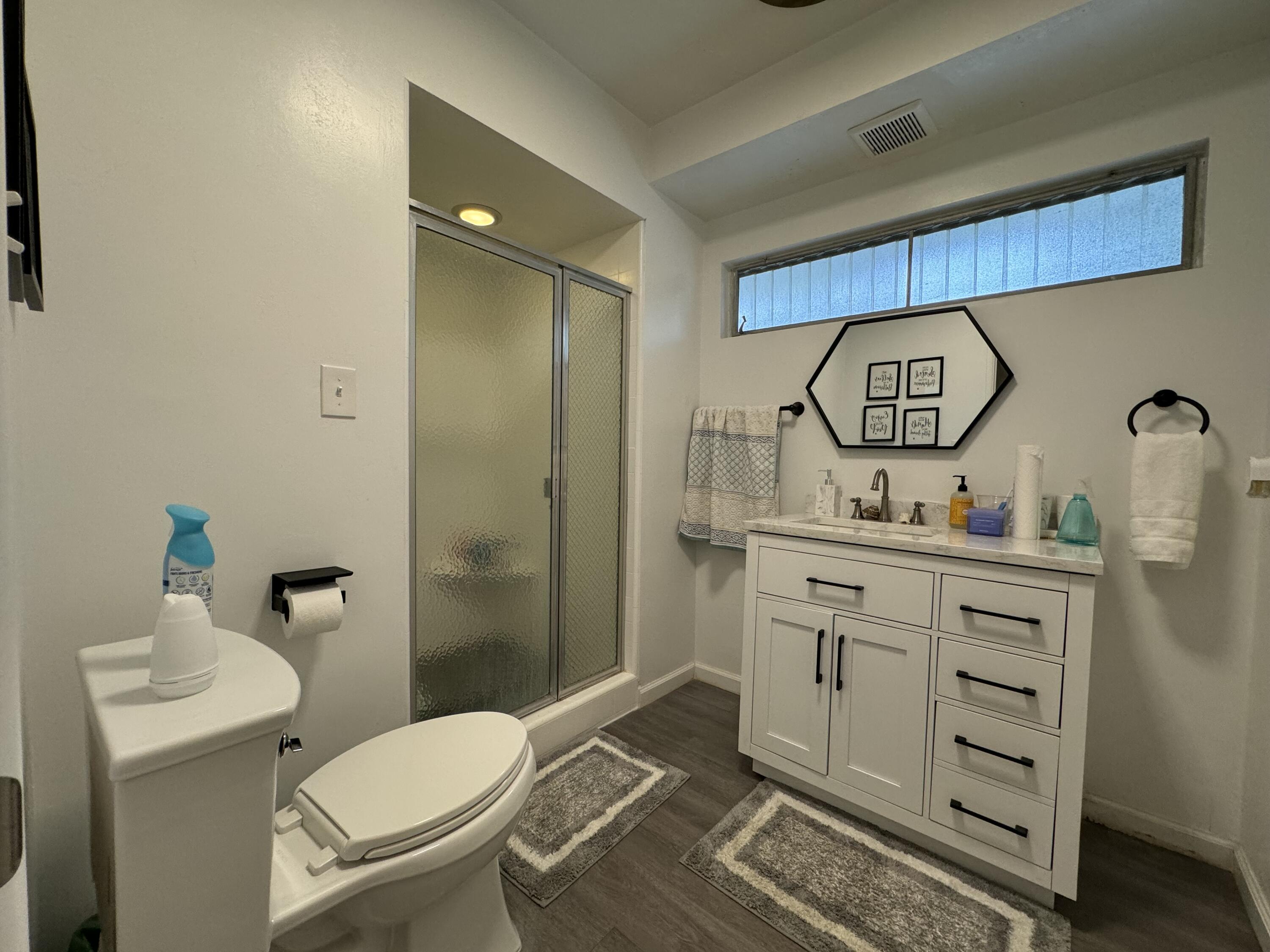 9748 Oak Pass Road Beverly Hills, CA 90210 - Photo 15 of 35 a bathroom with a toilet sink and mirror