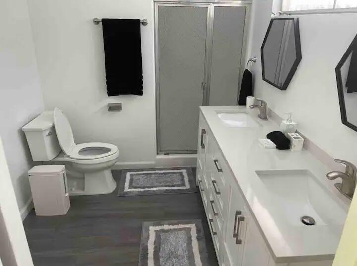 9748 Oak Pass Road Beverly Hills, CA 90210 - Photo 17 of 35 a bathroom with a sink a toilet and mirror