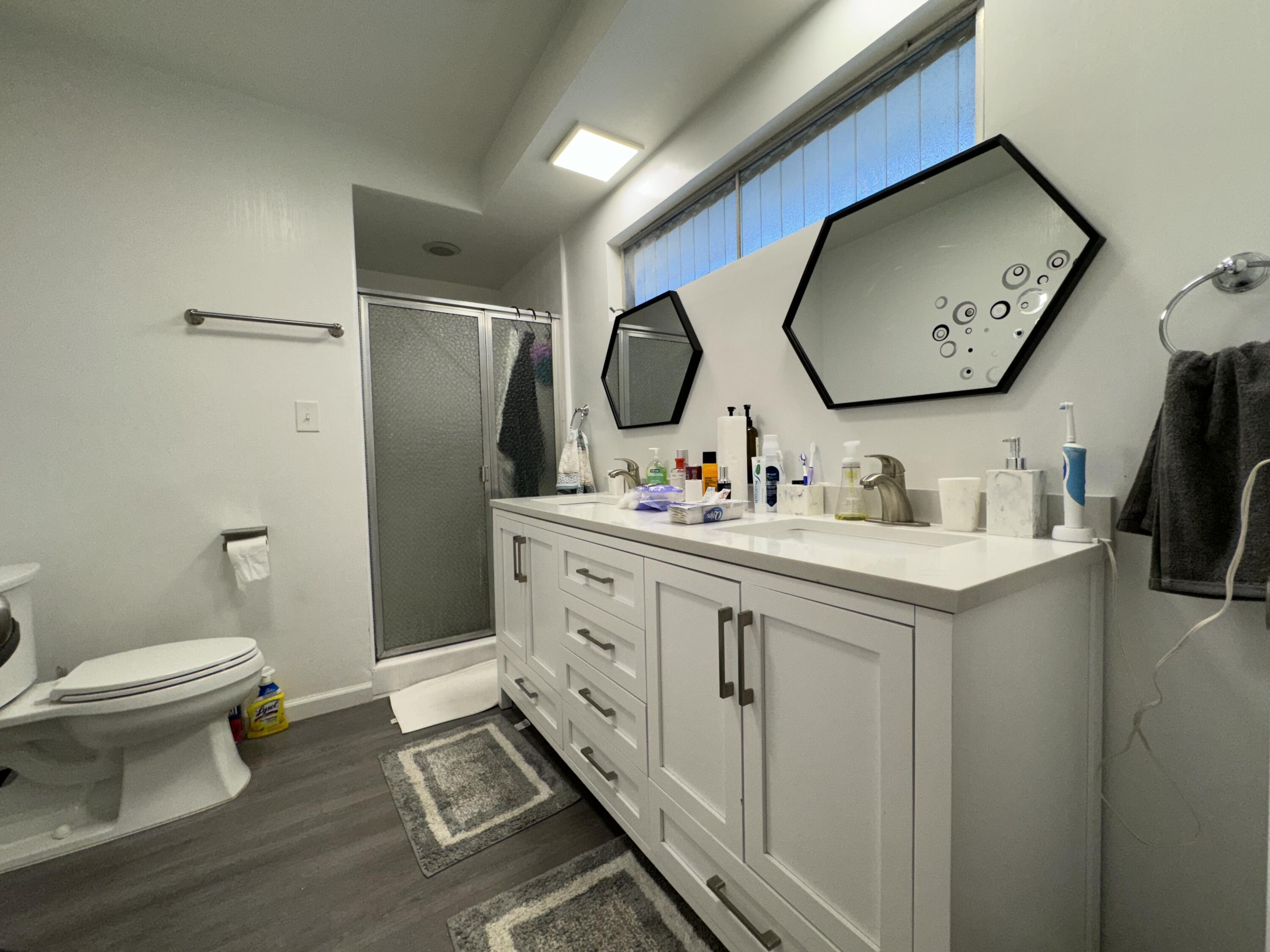 9748 Oak Pass Road Beverly Hills, CA 90210 - Photo 18 of 35 a bathroom with a toilet a sink and a mirror