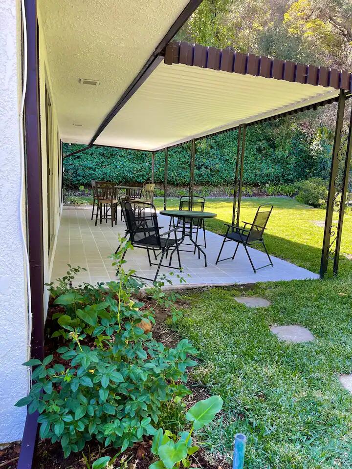9748 Oak Pass Road Beverly Hills, CA 90210 - Photo 22 of 35 a view of swimming pool with a table and chairs under an umbrella