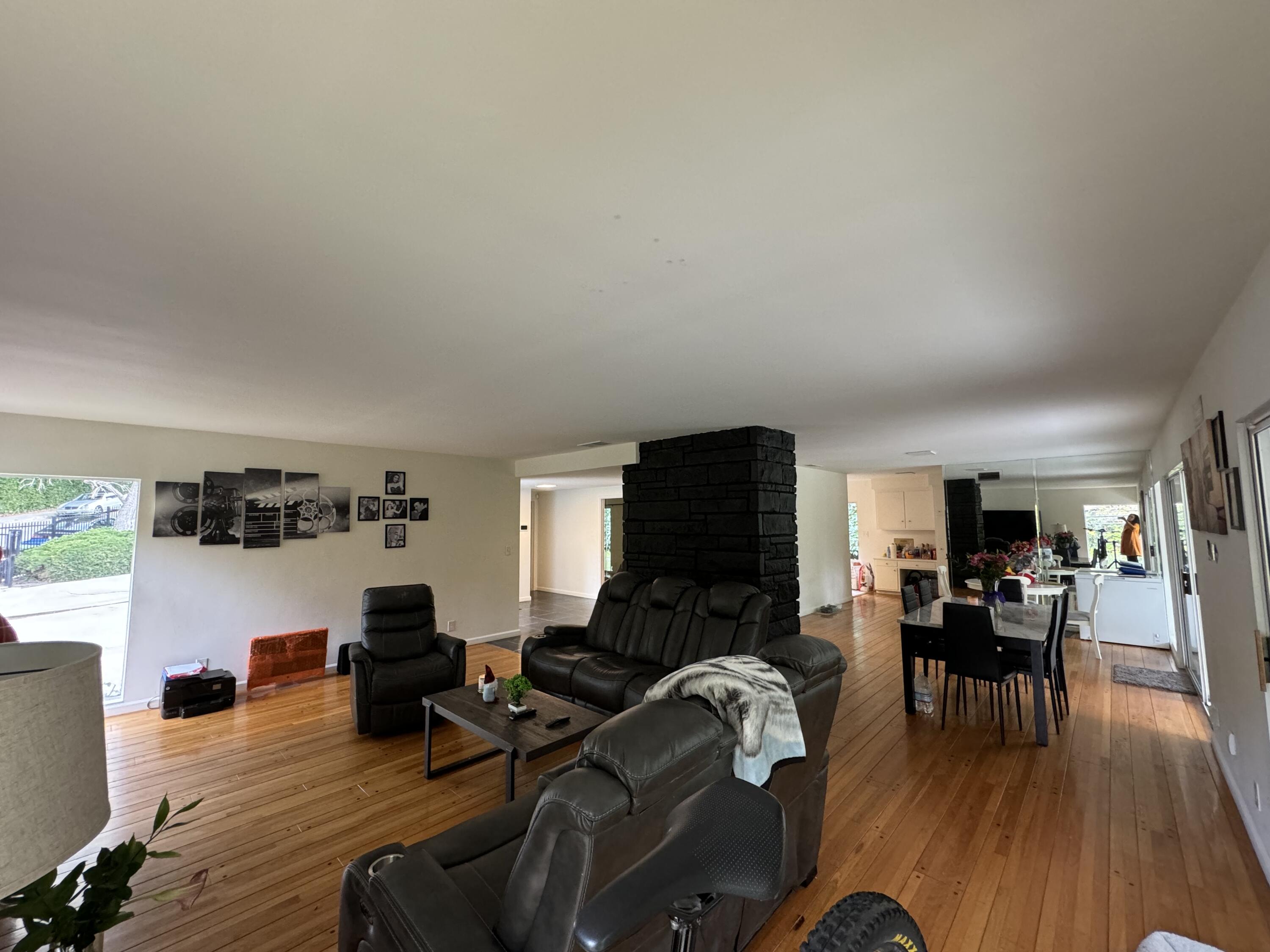 9748 Oak Pass Road Beverly Hills, CA 90210 - Photo 25 of 35 a living room with furniture and a wooden floor