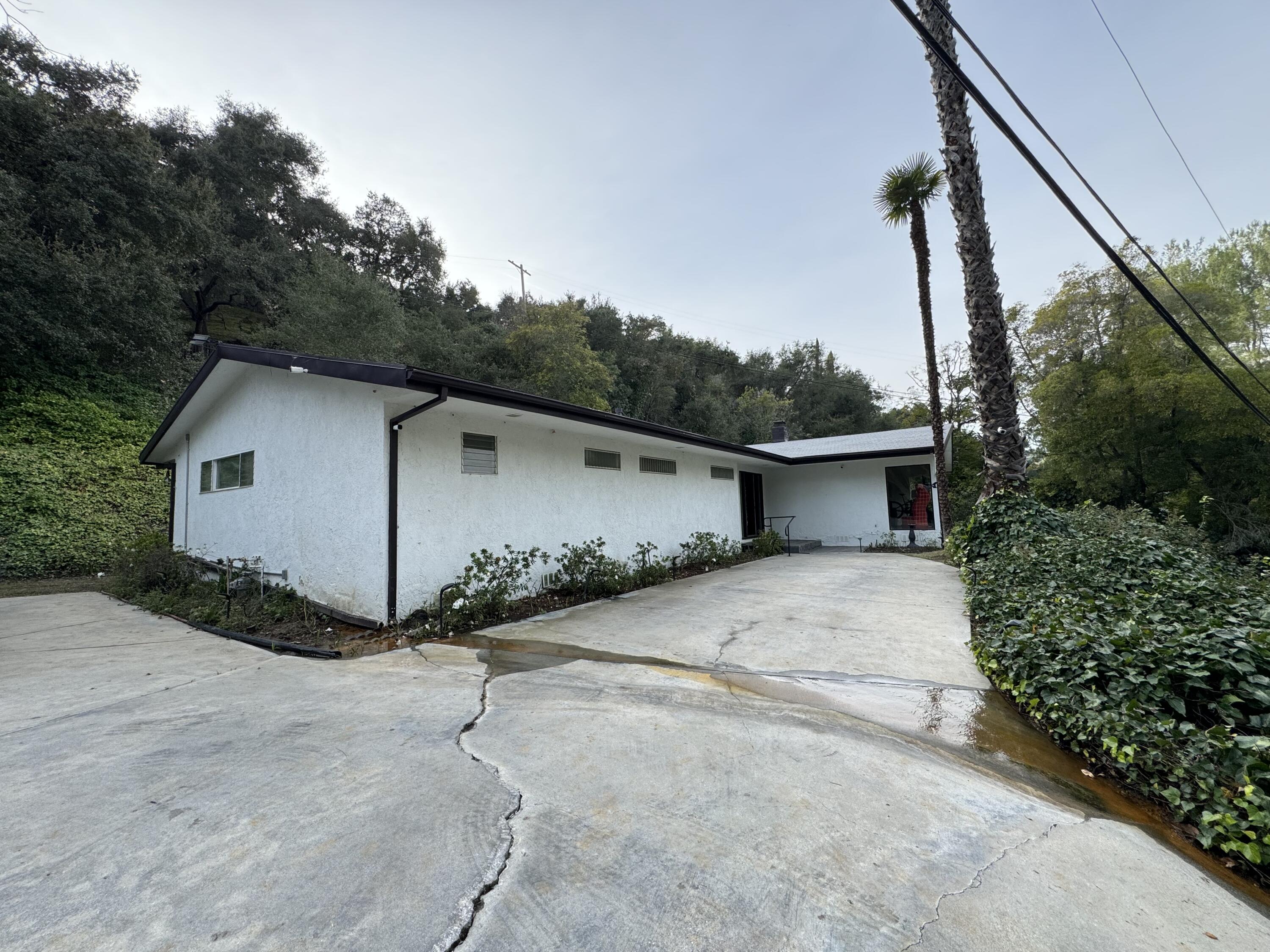 9748 Oak Pass Road Beverly Hills, CA 90210 - Photo 28 of 35 a view of a house with backyard