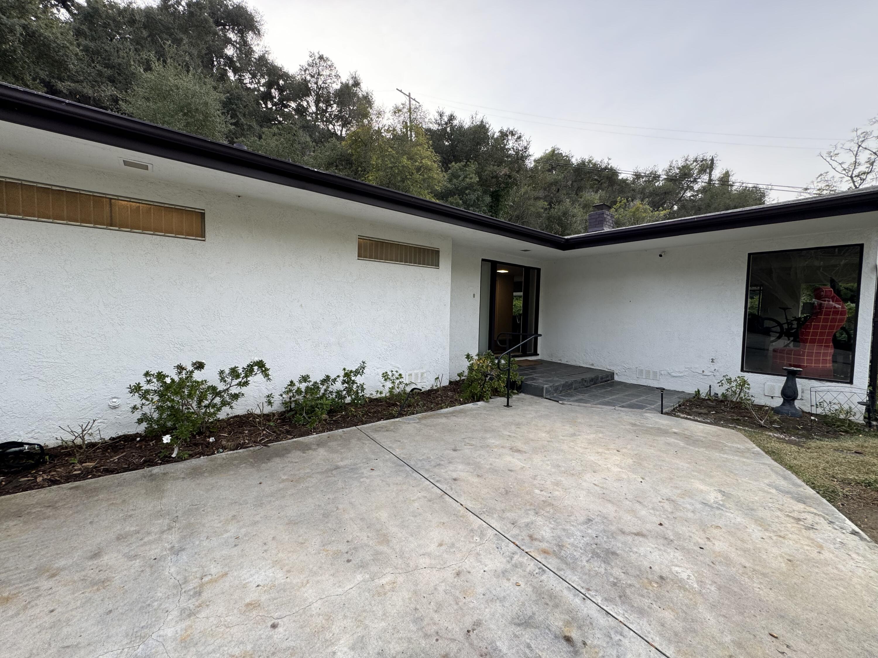 9748 Oak Pass Road Beverly Hills, CA 90210 - Photo 29 of 35 a backyard of a house with lots of trees and plants