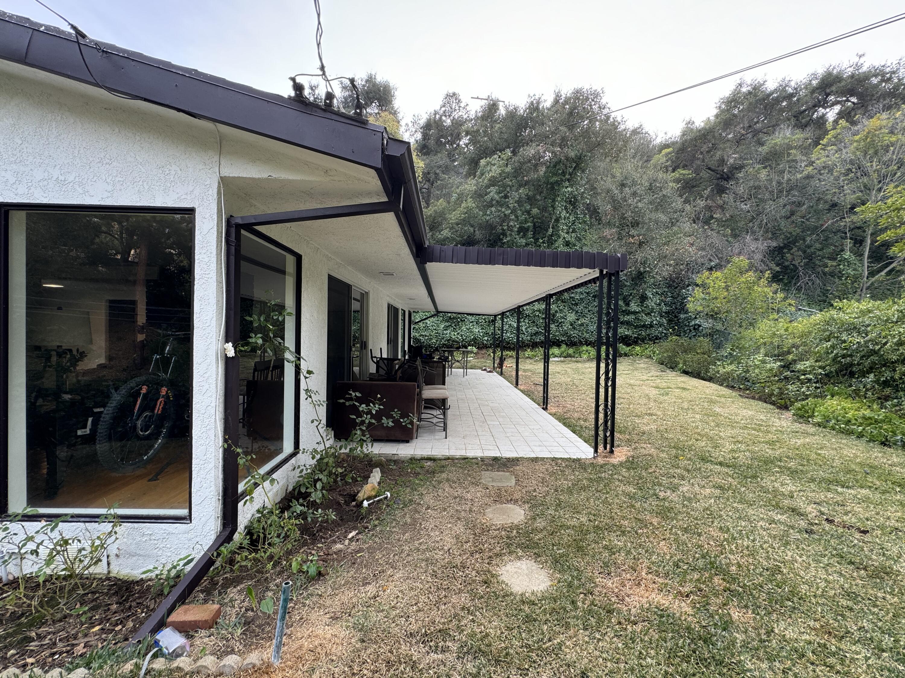 9748 Oak Pass Road Beverly Hills, CA 90210 - Photo 34 of 35 a view of a patio with a table and chairs