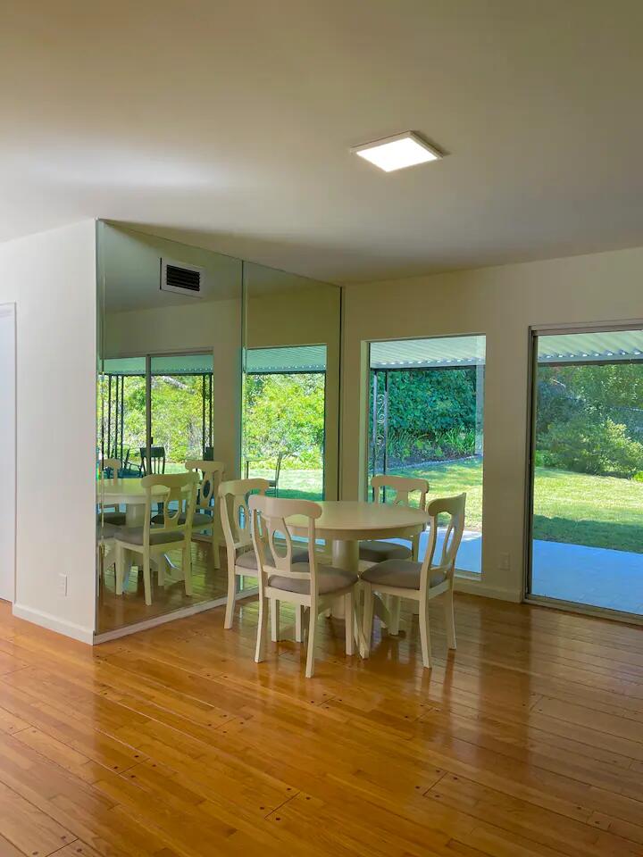 9748 Oak Pass Road Beverly Hills, CA 90210 - Photo 4 of 35 a dining room with furniture and wooden floor