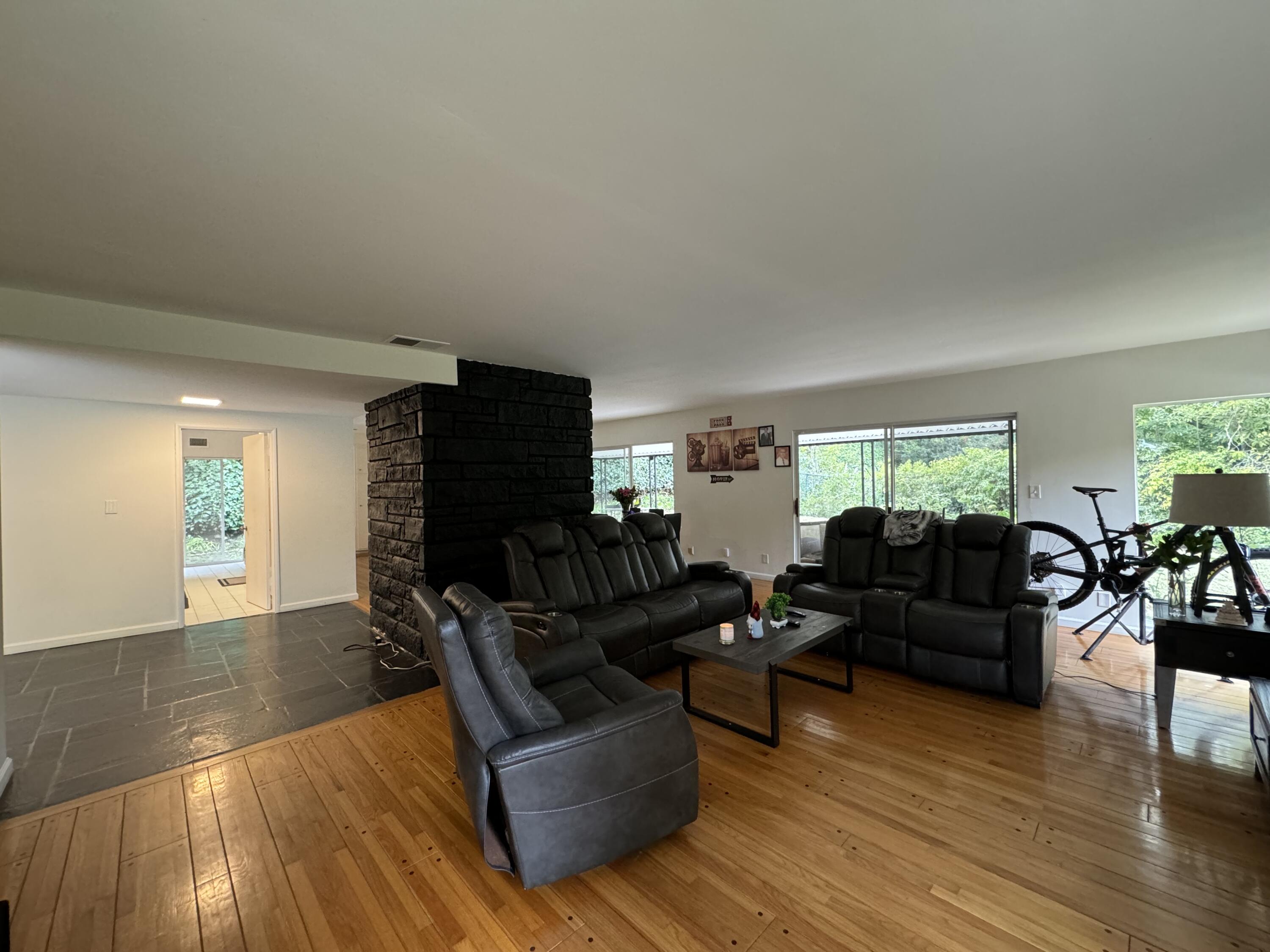 9748 Oak Pass Road Beverly Hills, CA 90210 - Photo 7 of 35 a living room with furniture and a flat screen tv