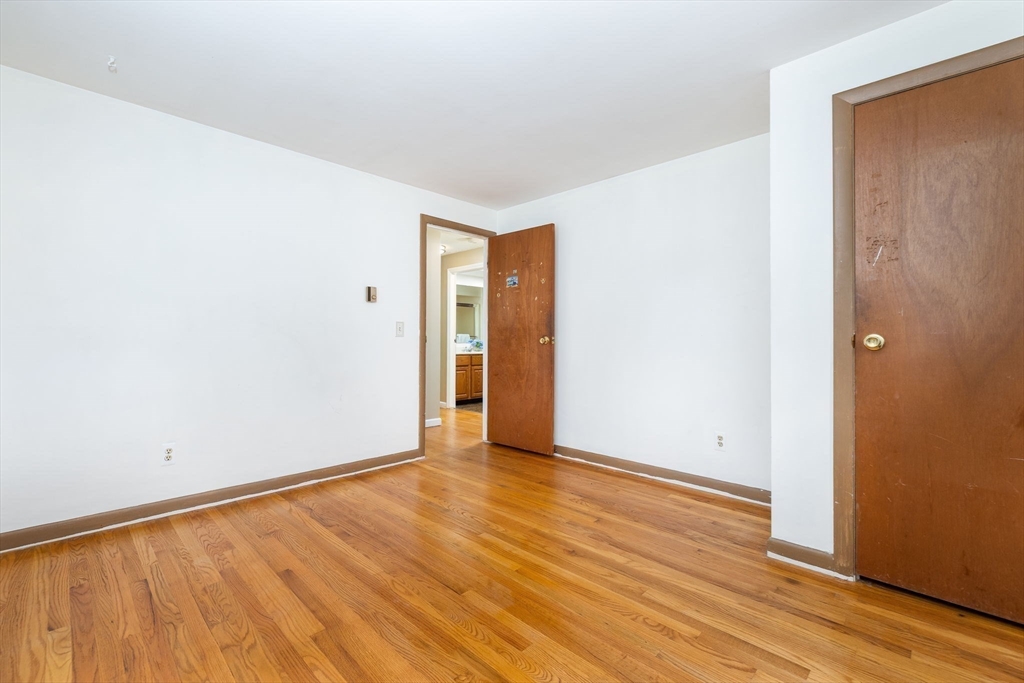 366 Peekskill Avenue Springfield, MA 01129 - Photo 24 of 31 an empty room with wooden floor and windows