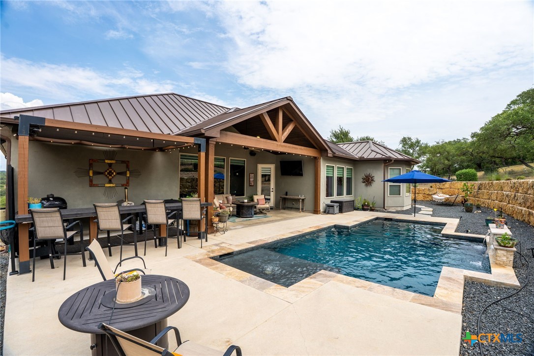 5943 Colin Ridge New Braunfels, TX 78132 - Photo 12 of 37 a view of a house with swimming pool and sitting area