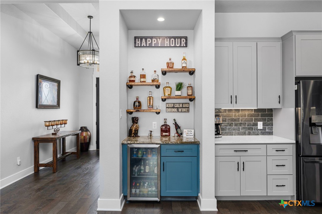 5943 Colin Ridge New Braunfels, TX 78132 - Photo 23 of 37 a kitchen with cabinets and wooden floor
