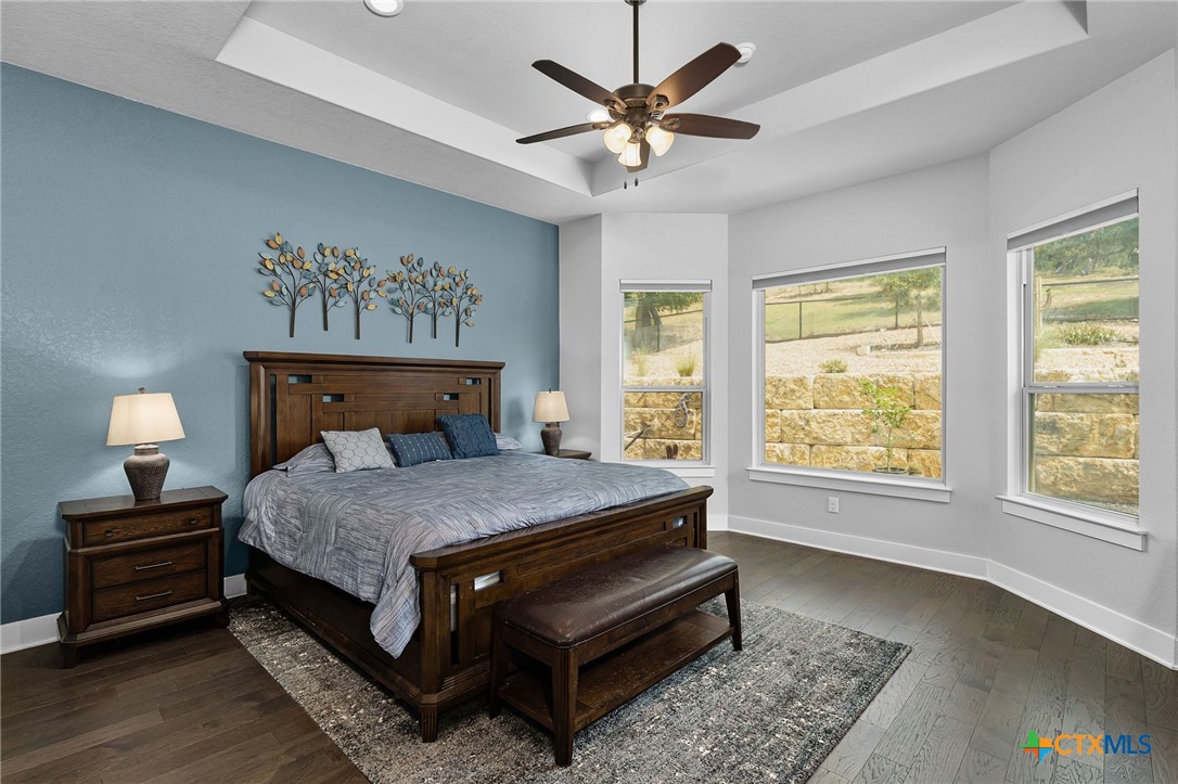5943 Colin Ridge New Braunfels, TX 78132 - Photo 24 of 37 a bedroom with a bed and a chandelier