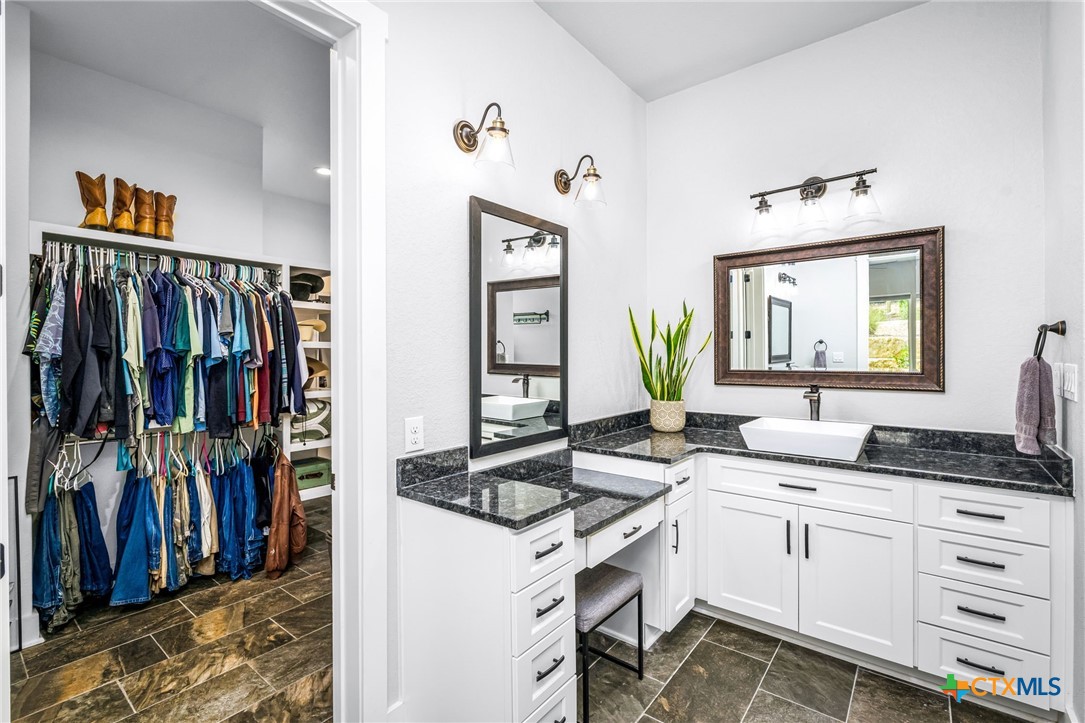 5943 Colin Ridge New Braunfels, TX 78132 - Photo 28 of 37 a spacious bathroom with a double vanity sink and a mirror