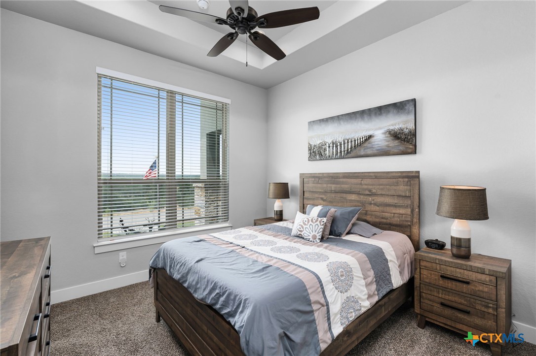 5943 Colin Ridge New Braunfels, TX 78132 - Photo 29 of 37 a bedroom with a large bed and a tv