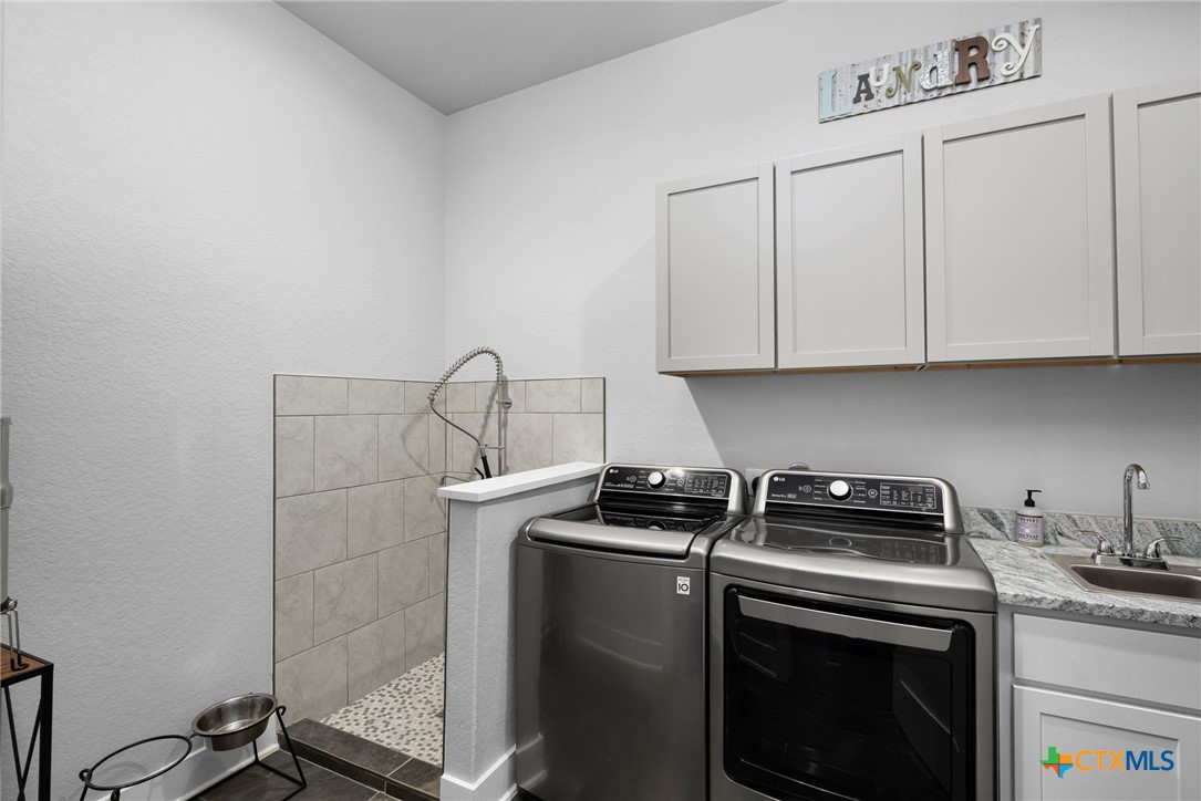 5943 Colin Ridge New Braunfels, TX 78132 - Photo 35 of 37 a kitchen with appliances cabinets and a stove top oven